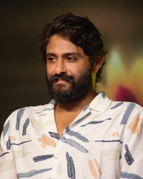 Antony Varghese in a white patterned shirt, half-length portrait