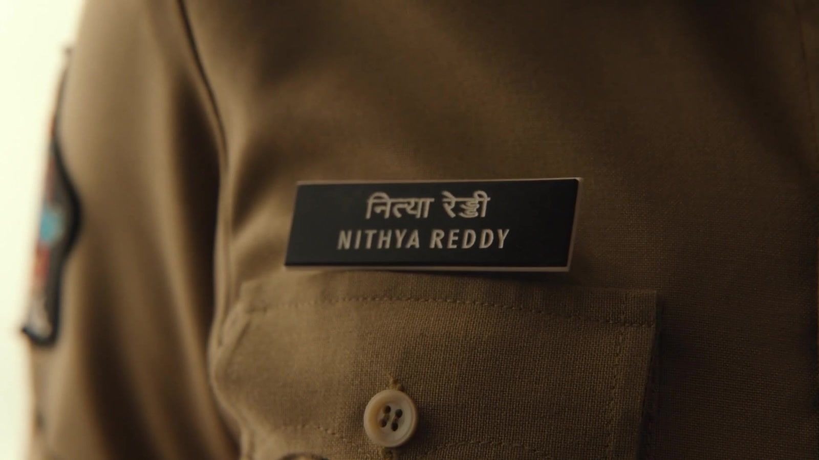 Nithya Reddy police name badge from the OM glimpse