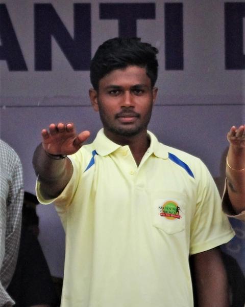 Sanju Samson smiling in a portrait photo