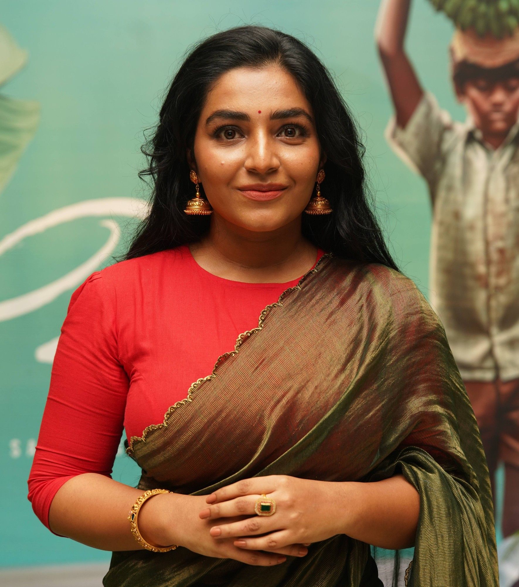 Rajisha Vijayan in a red blouse and saree, half-length portrait