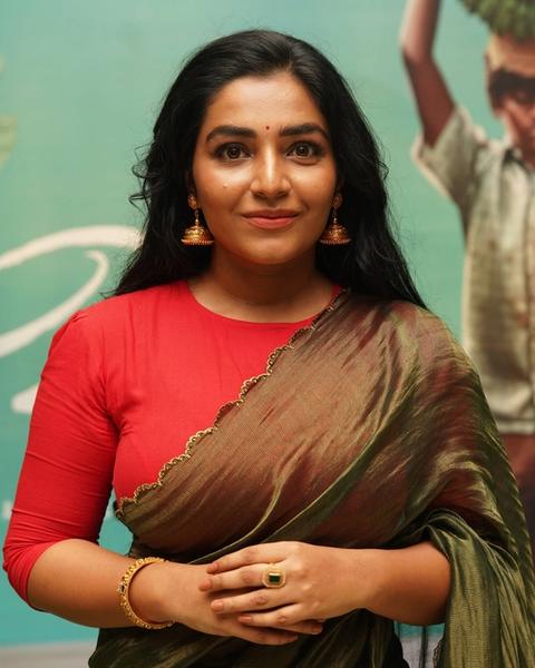 Rajisha Vijayan in a red blouse and saree, half-length portrait