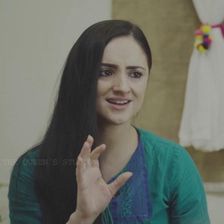 Paris Laxmi in a green top gesturing as she speaks