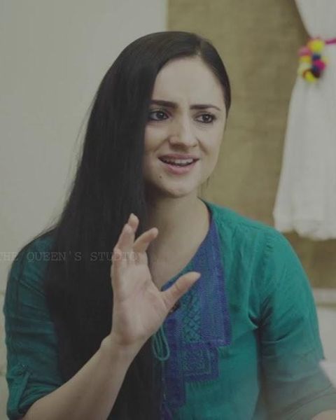 Paris Laxmi in a green top gesturing as she speaks