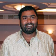Amal Neerad smiling in a light shirt in a hotel lobby