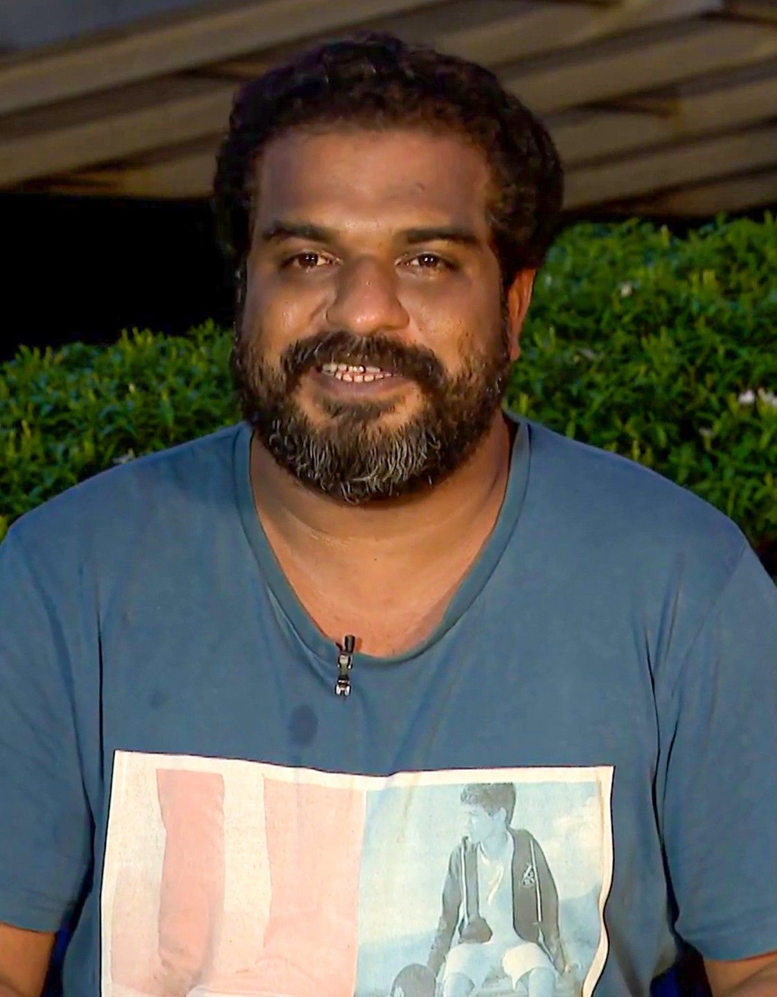 Dileesh Pothan with a beard in a blue T-shirt outdoors