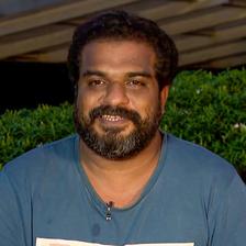 Dileesh Pothan with a beard in a blue T-shirt outdoors