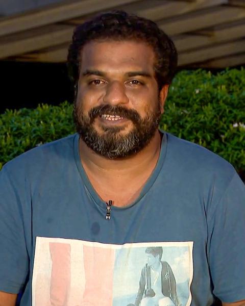 Dileesh Pothan with a beard in a blue T-shirt outdoors