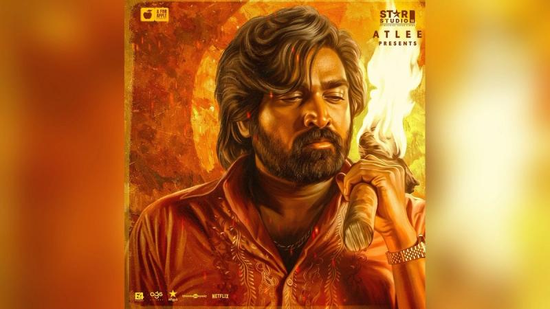 Vijay Sethupathi holding a flaming torch in the Baththa key art