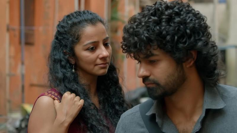 Darshana Rajendran and Pranav Mohanlal standing close in a street scene from the Hridayam trailer