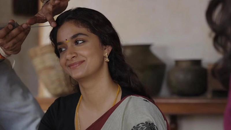 Keerthy Suresh smiling in a saree on the set of Dorothy
