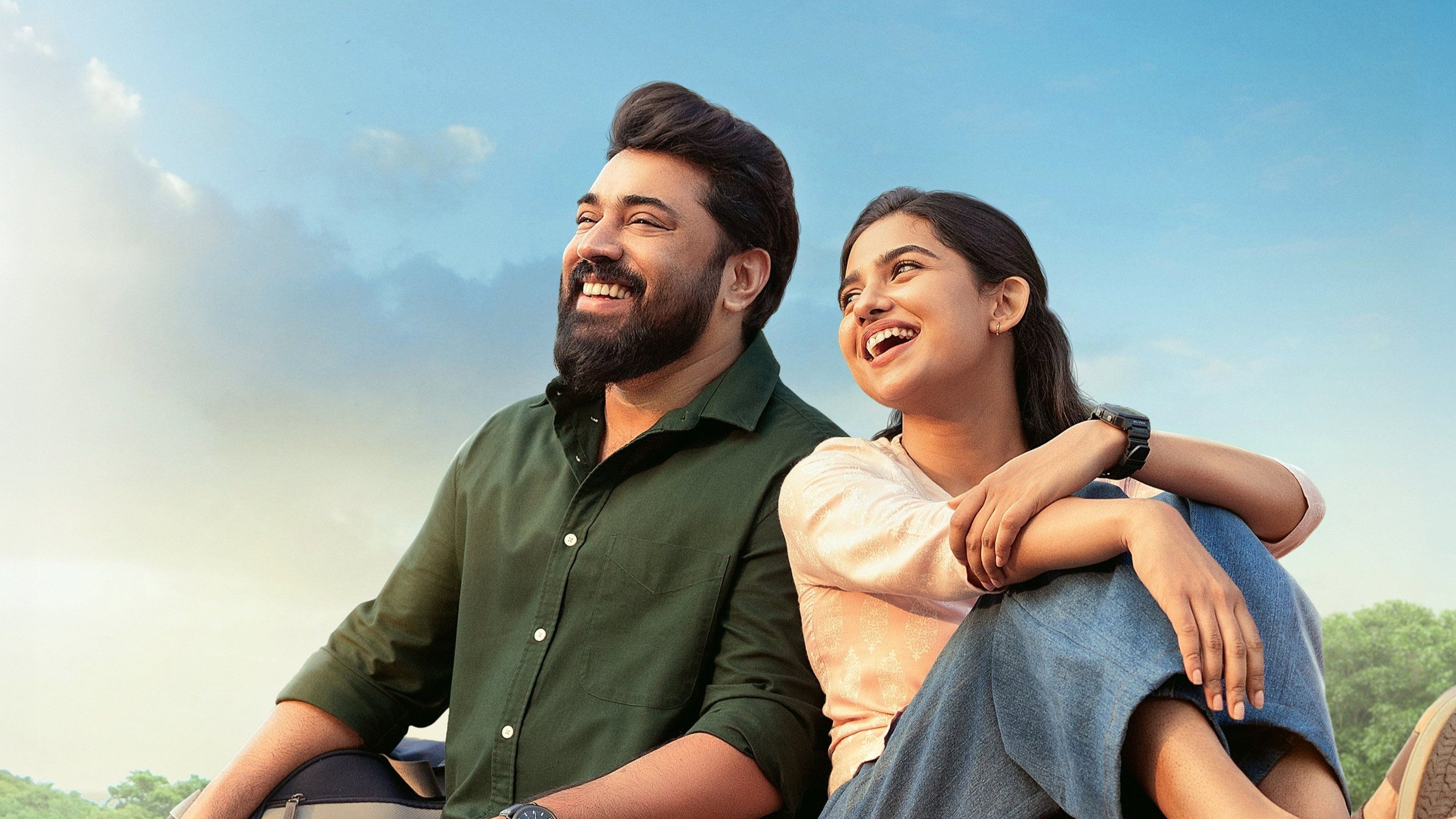 Bethlehem Kudumba Unit still of Nivin Pauly and Mamitha Baiju laughing on a balcony