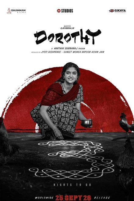Dorothy poster showing Keerthy Suresh in a red-and-black saree, smiling as she draws a kolam on the ground, with roosters around her and a red sun behind