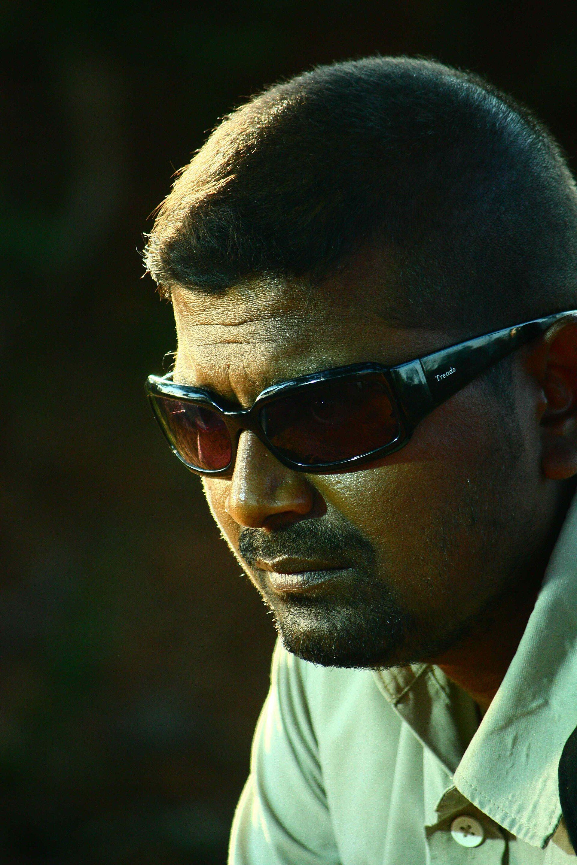 Mysskin in dark sunglasses, close-up side portrait