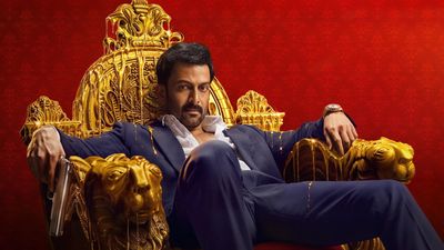 Khalifa still of Prithviraj Sukumaran in a suit seated on an ornate golden throne