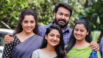 Drishyam 2 still of Mohanlal with Meena and their two daughters smiling together
