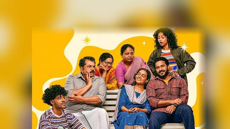 Manju Warrier, Mukesh, JP Thuminad and the cast of Happiloop on a bench in the film's first look poster