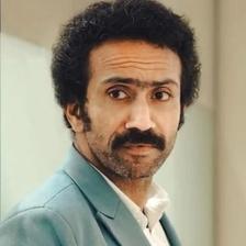 Shine Tom Chacko with a moustache in a teal suit, portrait
