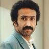 Shine Tom Chacko with a moustache in a teal suit, portrait