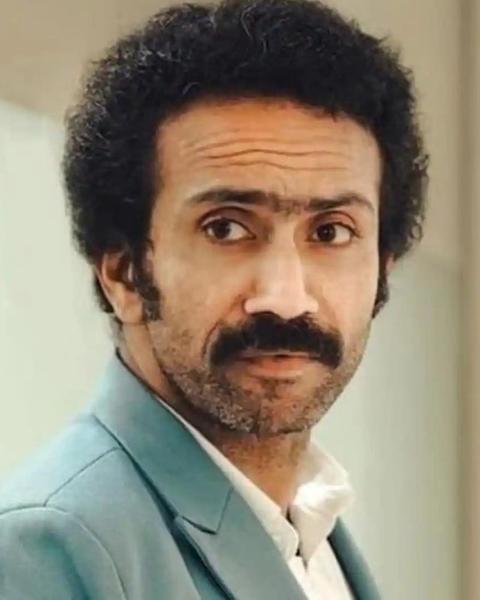 Shine Tom Chacko with a moustache in a teal suit, portrait