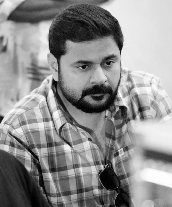 Ashiq Usman in a checked shirt, black and white portrait