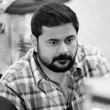 Ashiq Usman in a checked shirt, black and white portrait