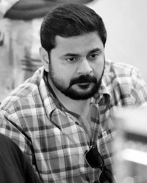 Ashiq Usman in a checked shirt, black and white portrait