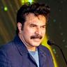 Mammootty speaking at a microphone in a blue denim jacket, 2022