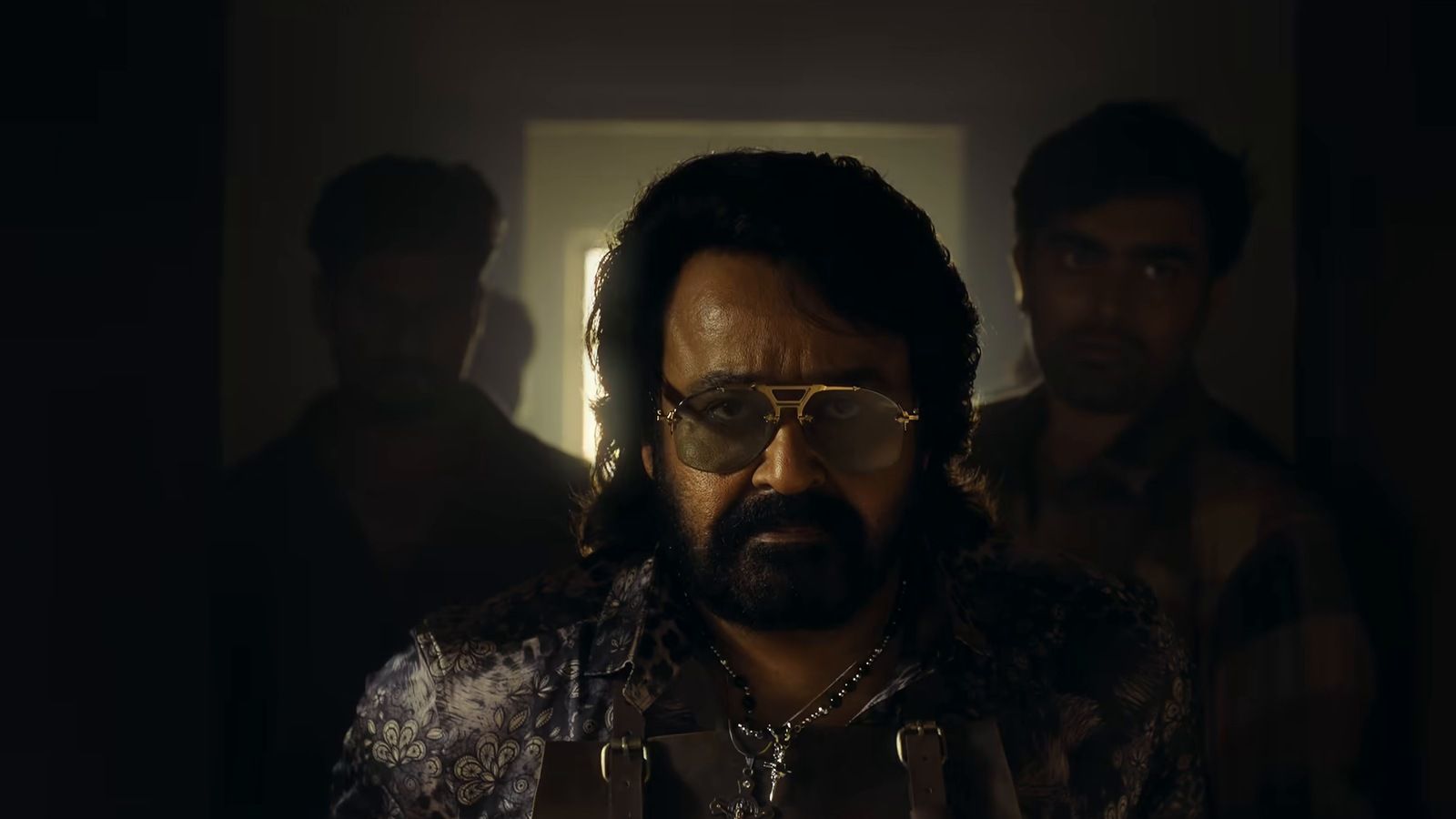 Mohanlal as Mathew in tinted glasses and a beard, in a dim room in the Jailer 2 trailer