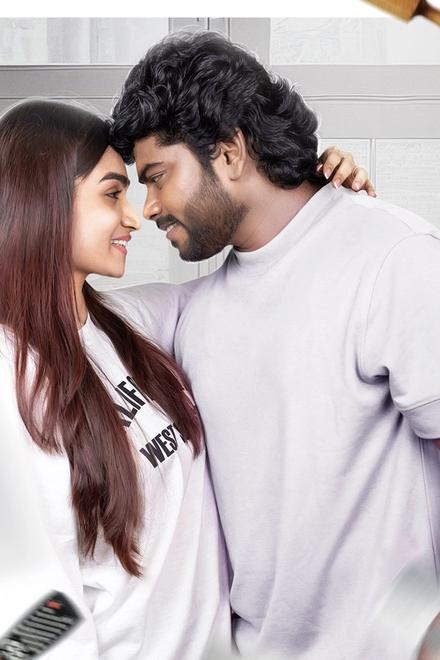 Dear Jeeva poster with the lead pair embracing in a bright kitchen