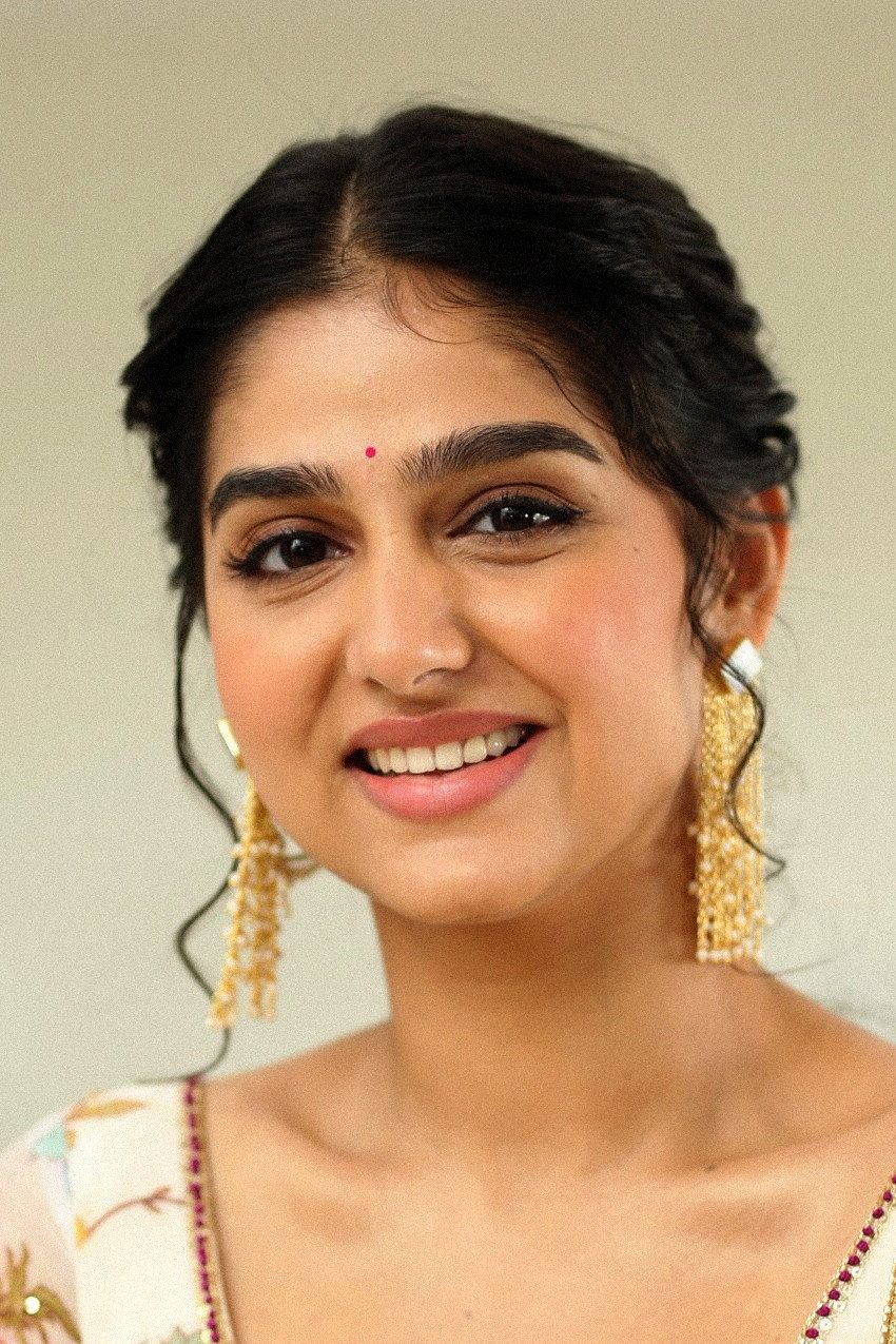 Anaswara Rajan smiling with a bindi and gold earrings, close-up portrait