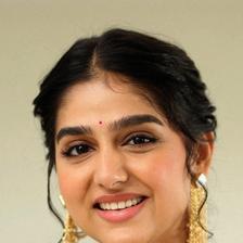 Anaswara Rajan smiling with a bindi and gold earrings, close-up portrait