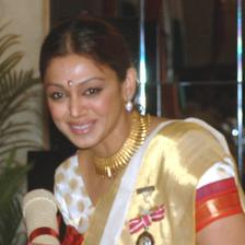 Shobana smiling in a cream and gold saree at the 2006 Padma Shri ceremony