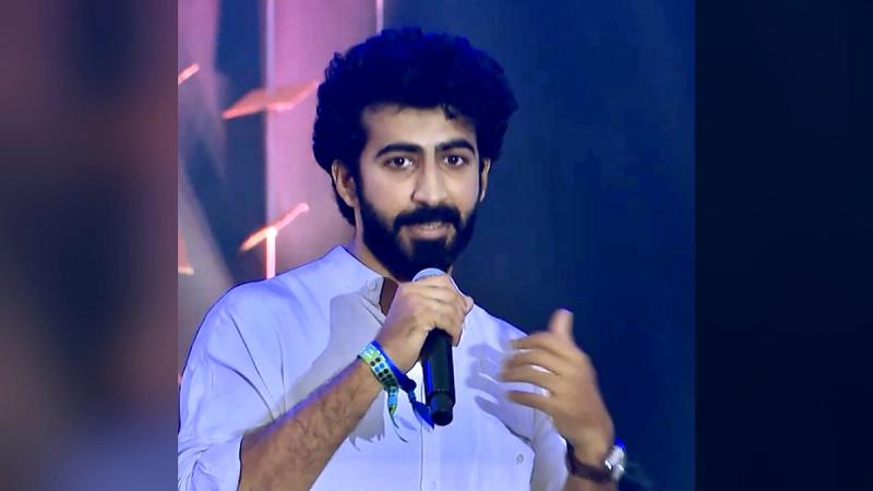 Malayalam actor Roshan Mathew speaking into a microphone on stage