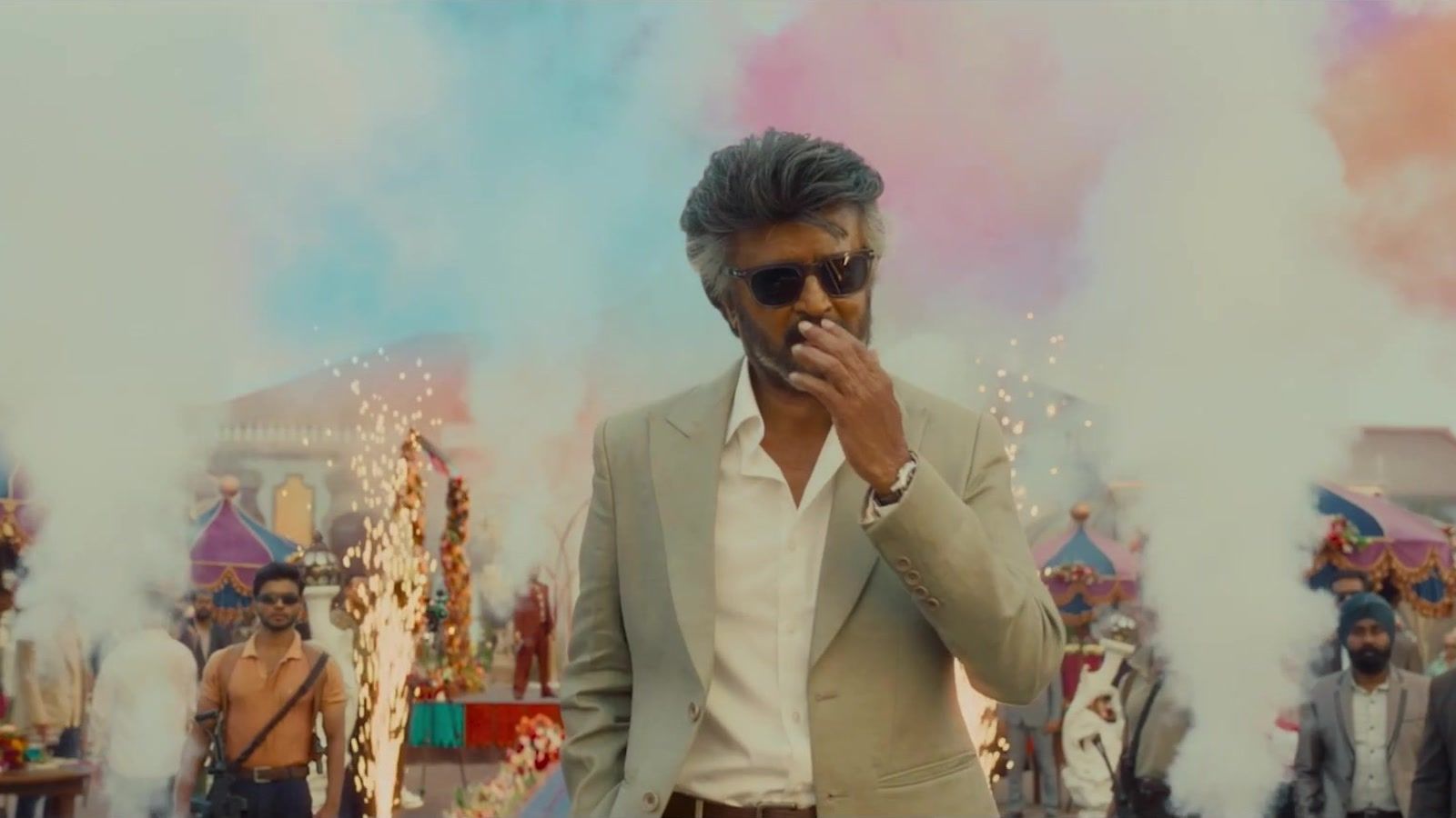 Rajinikanth in a cream suit and sunglasses at a fair in a Jailer 2 promo