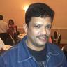 Jagadish smiling in a denim jacket at an indoor event