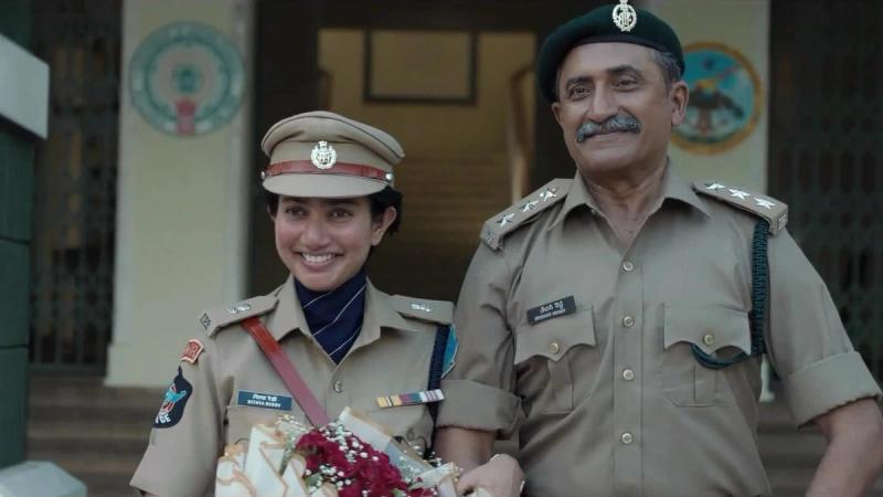 Sai Pallavi as police officer Nithya Reddy, smiling in uniform with a bouquet beside a senior officer, in the OM glimpse