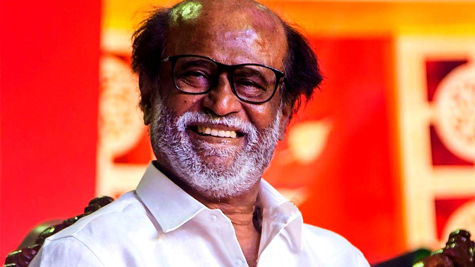 Rajinikanth smiling in glasses and a white shirt