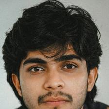 Naslen with tousled hair in a printed shirt, close-up portrait