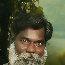 Rajan Poothrakkal with a long white beard, close-up portrait