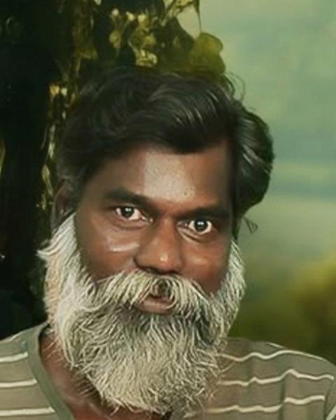 Rajan Poothrakkal with a long white beard, close-up portrait