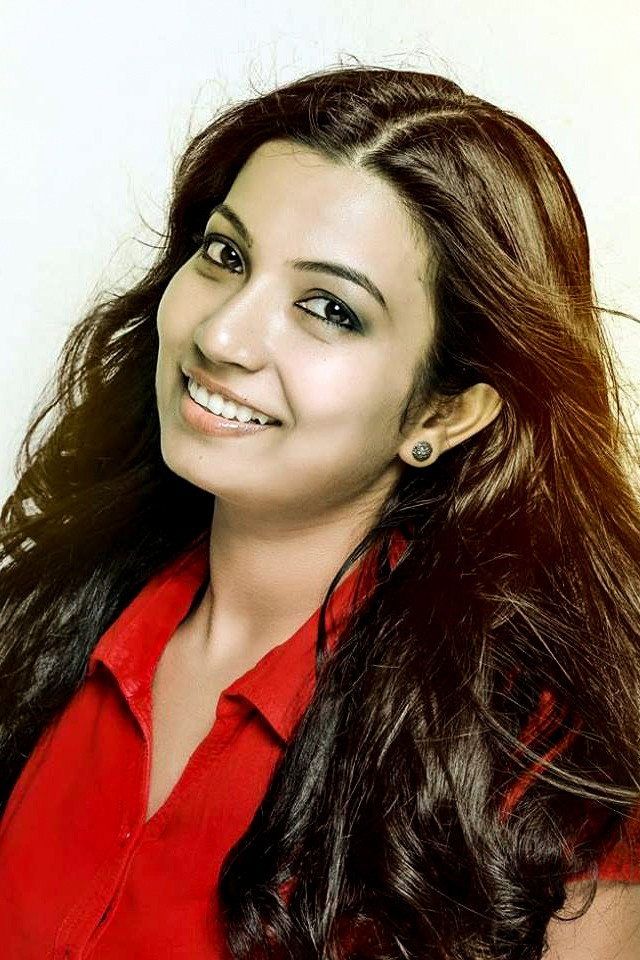 Sreeja Das smiling in a red top, close-up portrait
