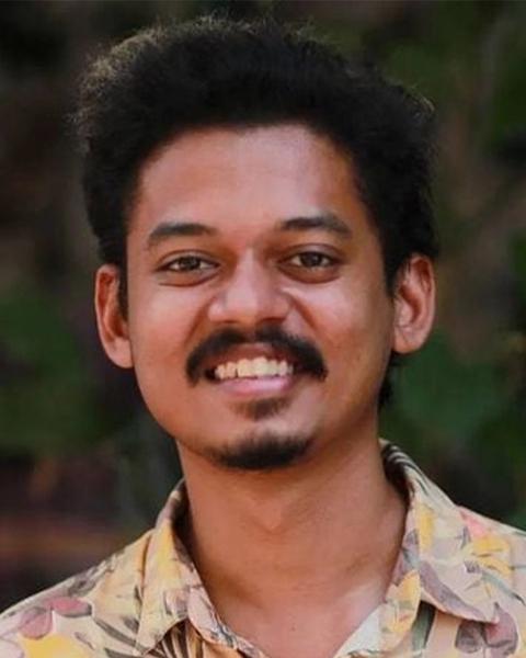 Sangeeth Prathap smiling in a printed shirt, close-up portrait