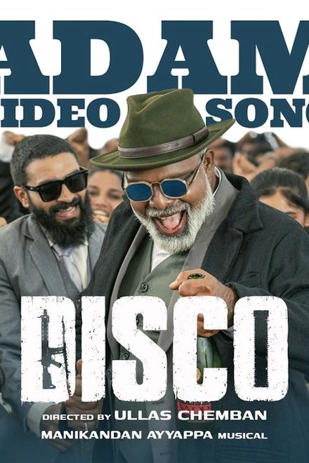 Disco Aadame song still with a grey-bearded man in a green hat and blue glasses dancing among a cheering crowd in suits