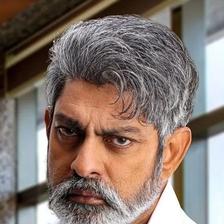 Jagapathi Babu with grey hair and beard in a white shirt