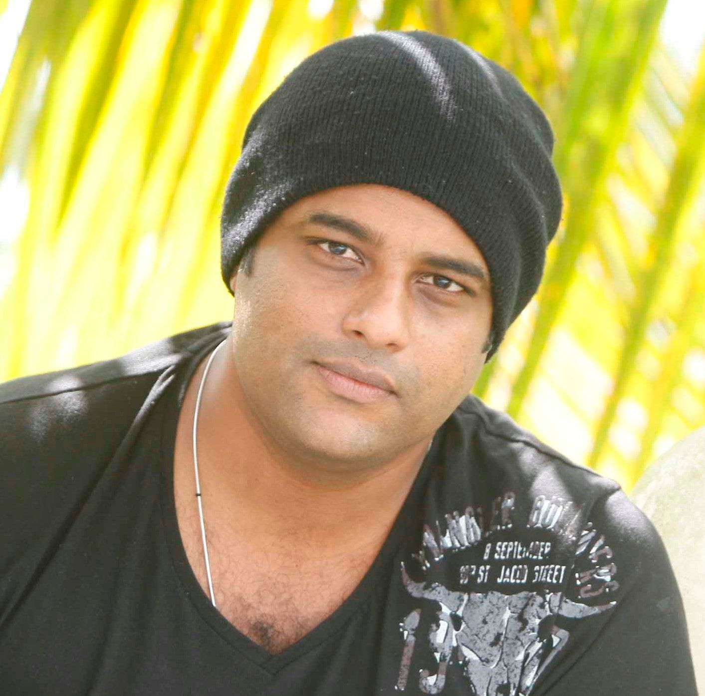 Murali Gopy in a black beanie and dark T-shirt outdoors