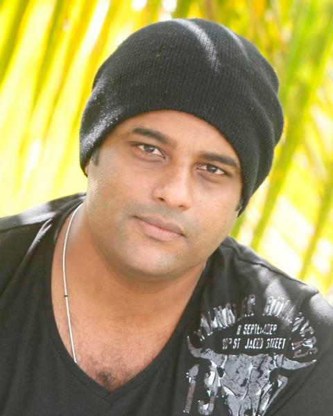 Murali Gopy in a black beanie and dark T-shirt outdoors