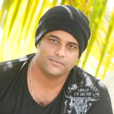 Murali Gopy in a black beanie and dark T-shirt outdoors