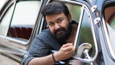 Thudarum still of Mohanlal leaning out of a car window, looking ahead