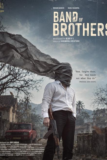 Band of Brothers first-look poster showing a man in a white shirt with his face wrapped in grey cloth, holding a rifle in a deserted village