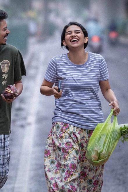 Hello Dear poster with Mamitha Baiju laughing on a street holding a shopping bag